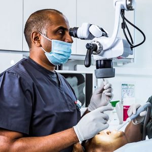 Specialist dentist using a microscope